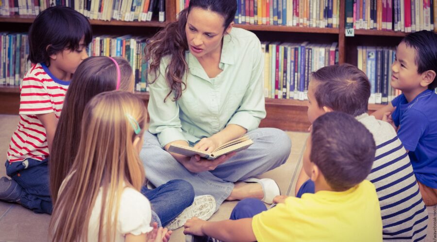 teacher sitting with class