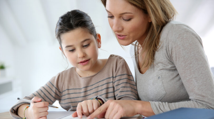 Mother helping daughter with homework