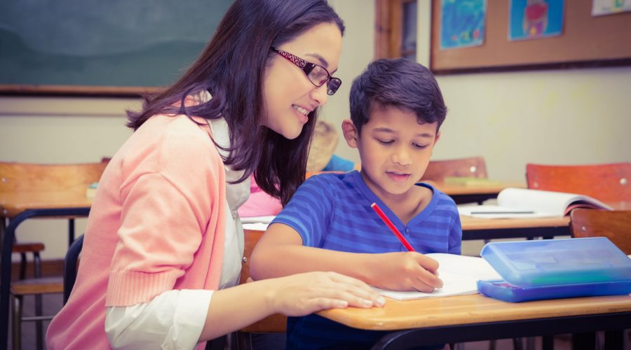 Teacher helping student