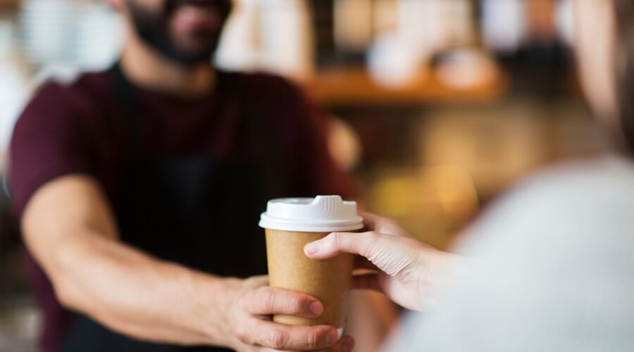 Customer taking cup of coffee