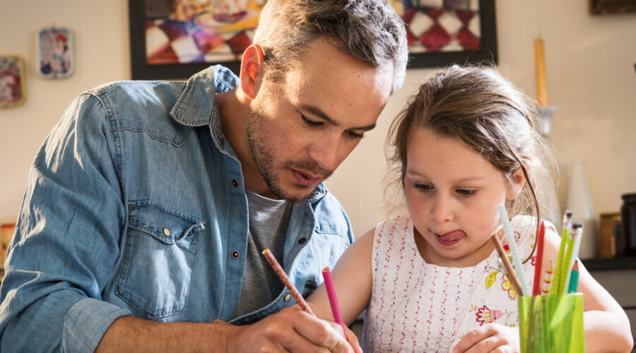 Dad helping daughter study