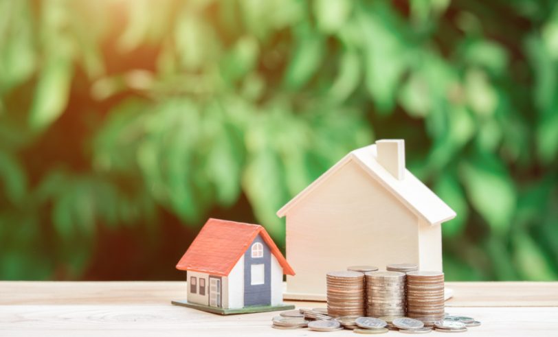 Coins next to a house