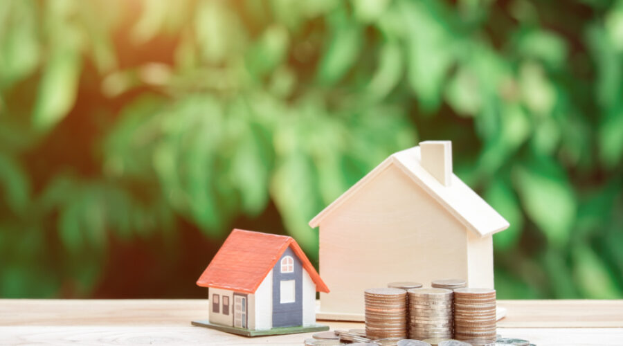 Coins next to a house