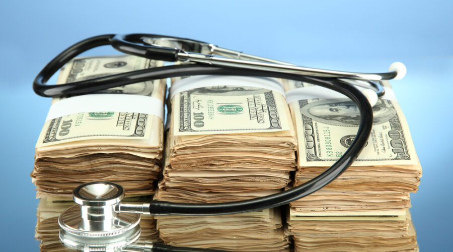 Stethoscope around stacks of bills