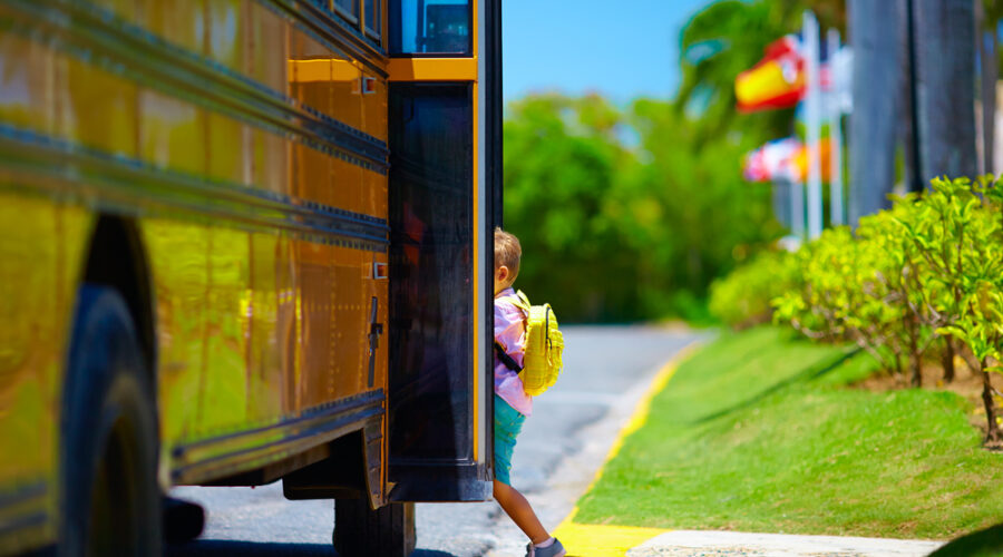 Kid getting on school bus