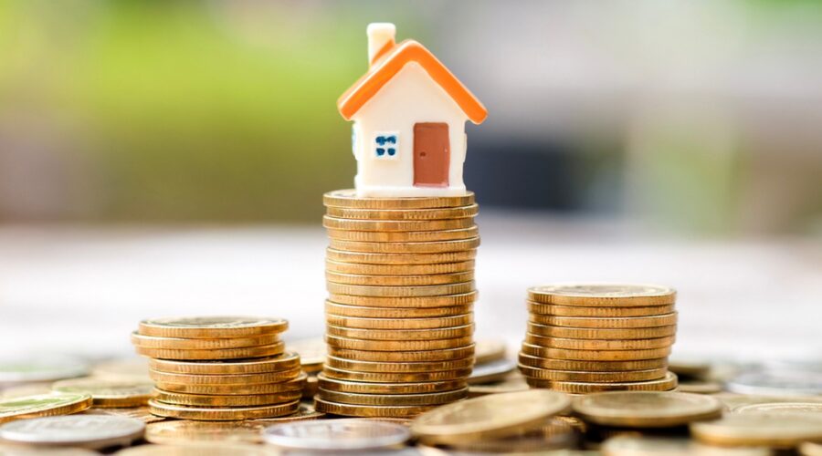 Pile of coins on house