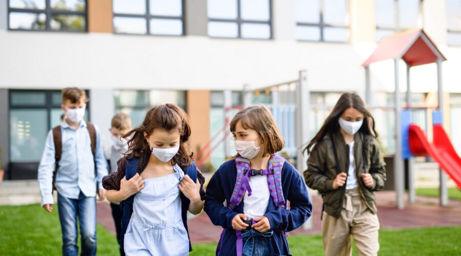 Students wearing masks leaving school