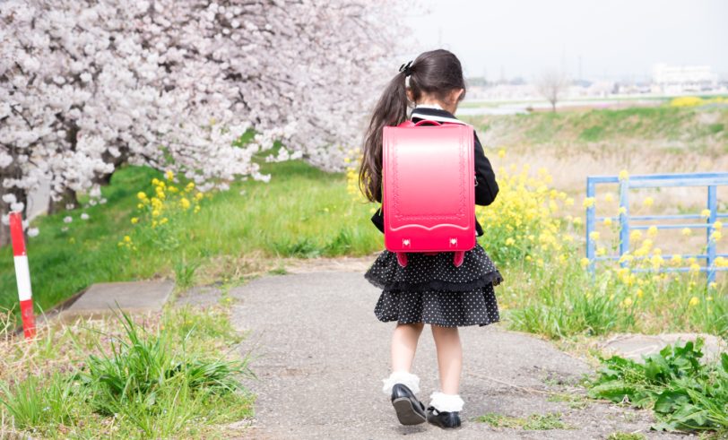 Young girl walking alone to school