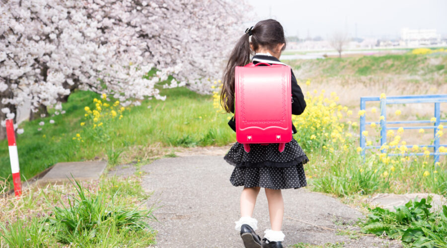 Young girl walking alone to school