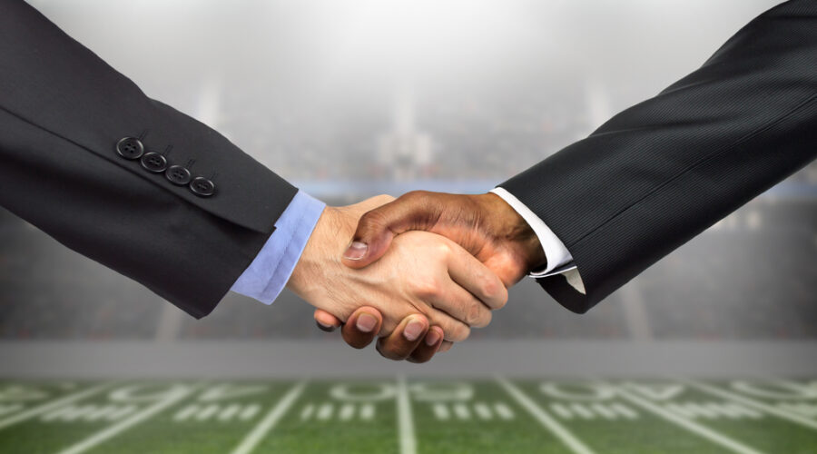 Handshake superimposed over football field