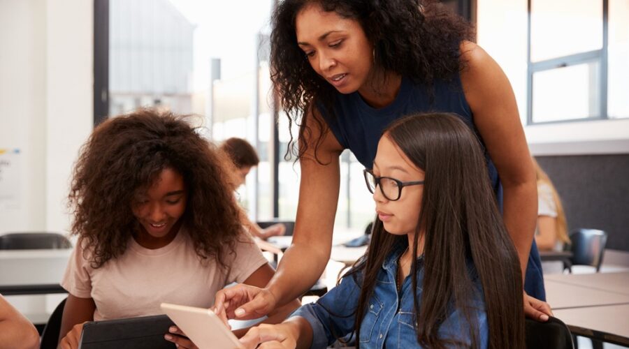 Teacher helping students