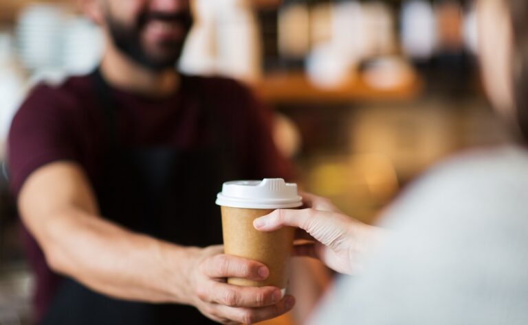 Customer taking cup of coffee