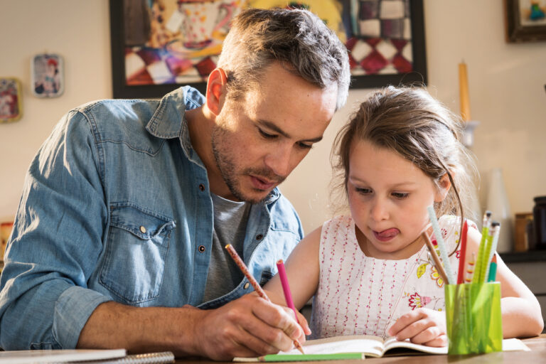 Dad helping daughter study