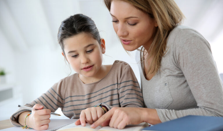 Mother helping daughter with homework