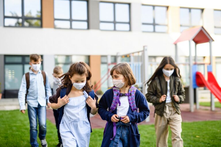 Students wearing masks leaving school