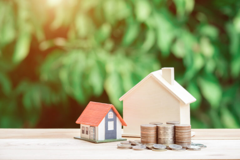 Coins next to a house