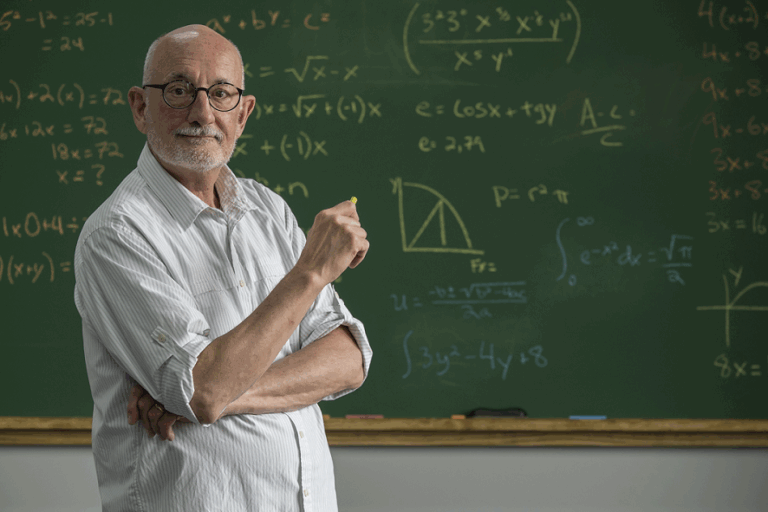 Teacher in front of chalkboard
