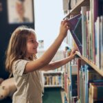 Child with book, early literacy, three-cueing system, phonics, reading instruction, Missouri literacy