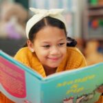 Girl reading book, literacy policy, Missouri reading scores, phonics, three cueing method